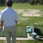 golfer begining process to his golf pre shot routine on the driving range