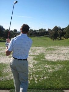 golfer walks through pre-shot routine hittina golf shot