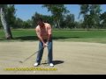 hitting golf ball out of fairway bunker